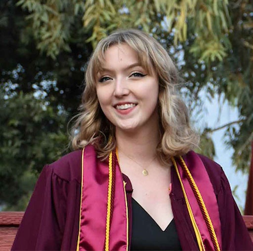 Rachael graduation photo wearing gown