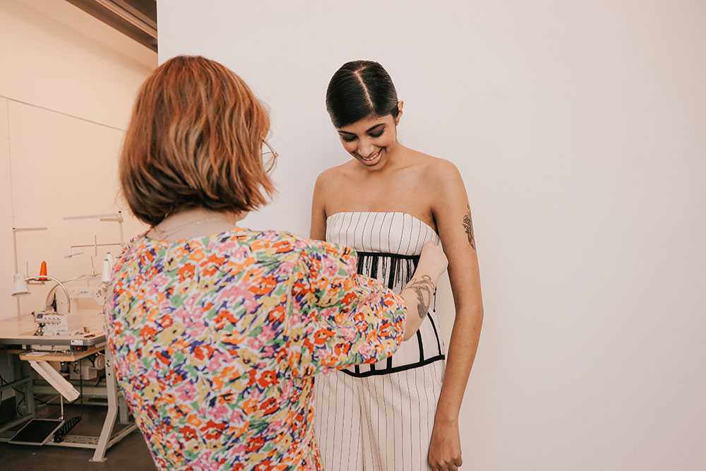Students trying on a dress
